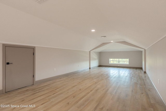 additional living space featuring recessed lighting, baseboards, light wood finished floors, and lofted ceiling