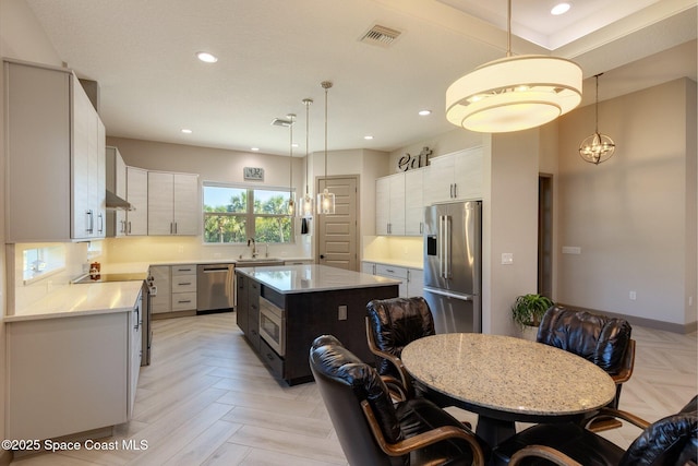kitchen featuring light countertops, appliances with stainless steel finishes, recessed lighting, and visible vents