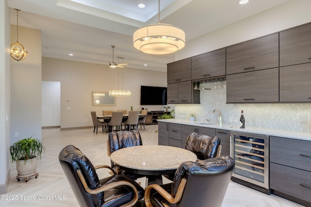 dining area featuring wine cooler, baseboards, recessed lighting, bar, and a ceiling fan