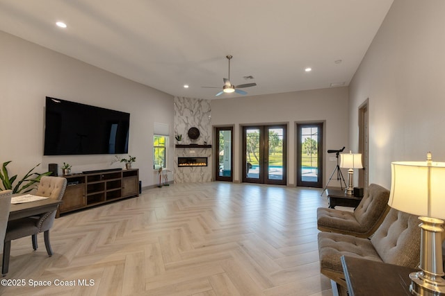 living area with ceiling fan, a fireplace, recessed lighting, and visible vents