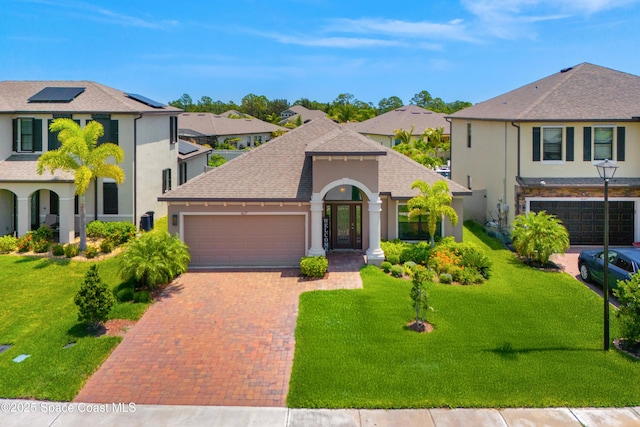 4637 Broomsedge Cir, West Melbourne, FL 32904 - view of front of house with stucco siding, an attached garage, decorative driveway, and a front lawn