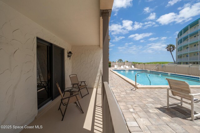 community pool featuring a fenced backyard