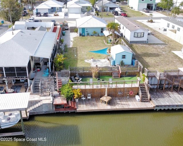 birds eye view of property featuring a water view and a residential view