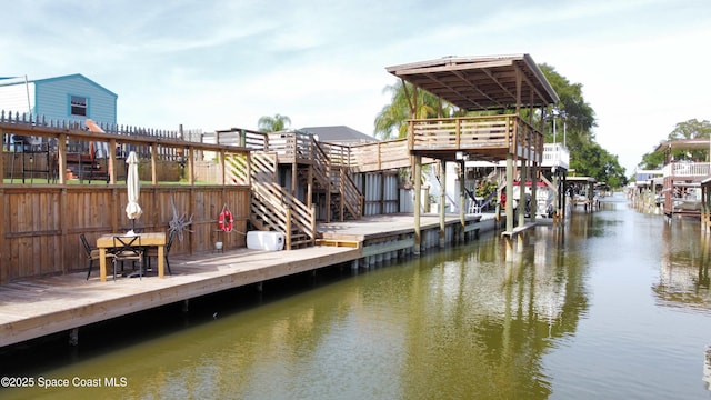 dock area featuring a deck with water view and stairway