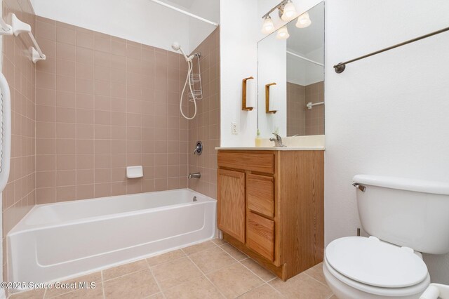 bathroom featuring shower / tub combination, toilet, tile patterned flooring, and vanity