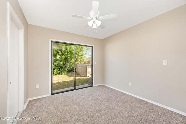spare room with carpet floors, baseboards, and a ceiling fan