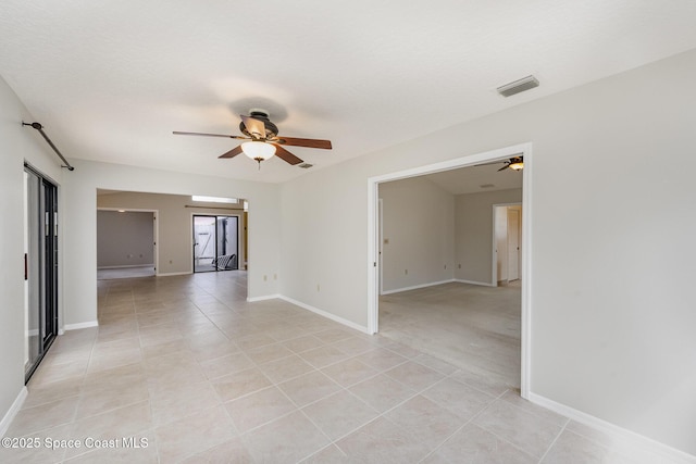 unfurnished room featuring ceiling fan, light tile patterned flooring, baseboards, and visible vents