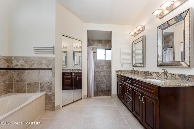 bathroom featuring a sink, tile patterned floors, tile walls, tiled shower, and a bath