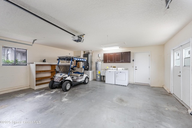 garage with a garage door opener, heating unit, water heater, and washing machine and clothes dryer
