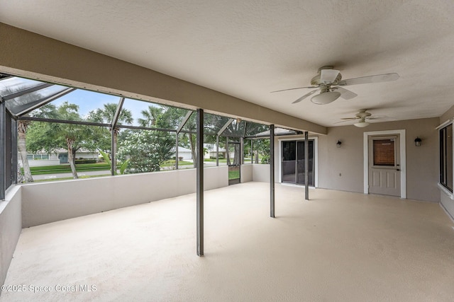 unfurnished sunroom with a ceiling fan