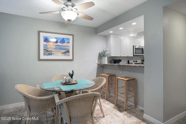 dining area with baseboards, a ceiling fan, and recessed lighting
