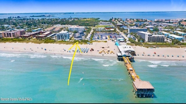 birds eye view of property featuring a water view and a view of the beach