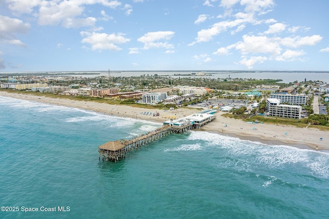 drone / aerial view featuring a water view and a view of the beach