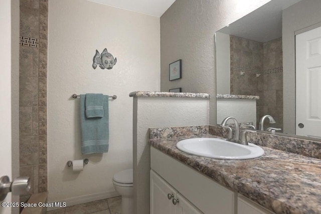 full bathroom featuring vanity, baseboards, tile patterned flooring, and toilet