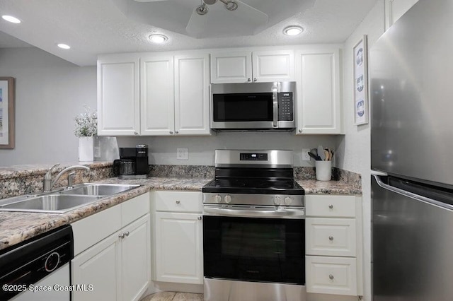 5350 Ocean Beach Blvd Unit 207, Cocoa Beach, FL 32931 - kitchen with appliances with stainless steel finishes, a sink, white cabinets, and recessed lighting