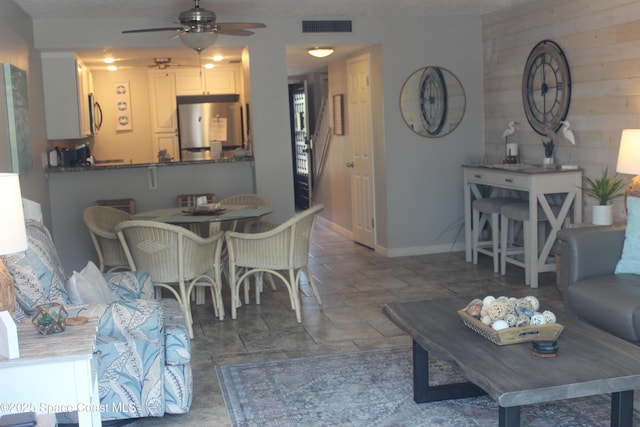 5350 Ocean Beach Blvd Unit 207, Cocoa Beach, FL 32931 - living room featuring ceiling fan and baseboards
