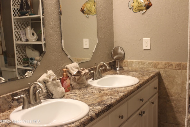 5350 Ocean Beach Blvd Unit 207, Cocoa Beach, FL 32931 - bathroom featuring double vanity and a textured wall