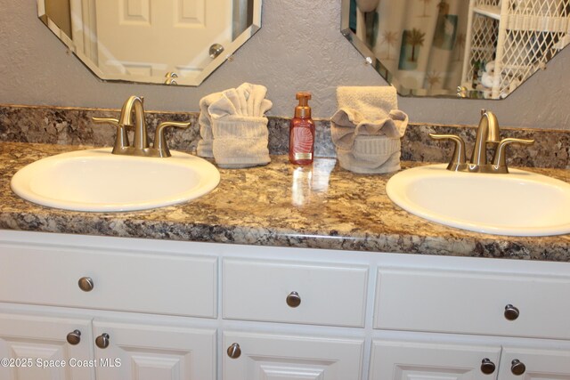 5350 Ocean Beach Blvd Unit 207, Cocoa Beach, FL 32931 - full bathroom with double vanity and a textured wall