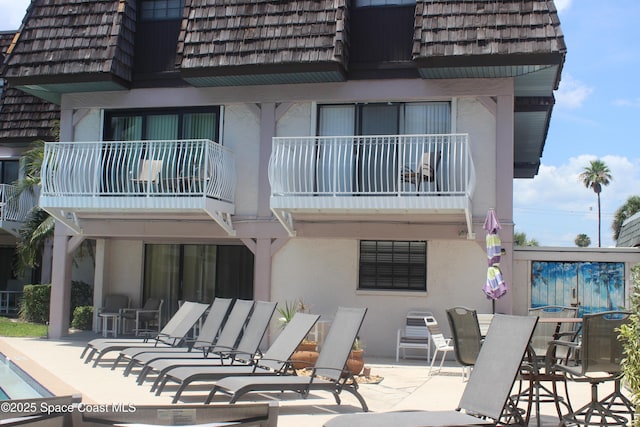 5350 Ocean Beach Blvd Unit 207, Cocoa Beach, FL 32931 - back of house with stucco siding and a balcony