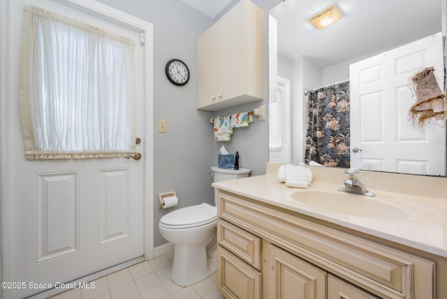 bathroom with tile patterned floors, toilet, baseboards, vanity, and curtained shower