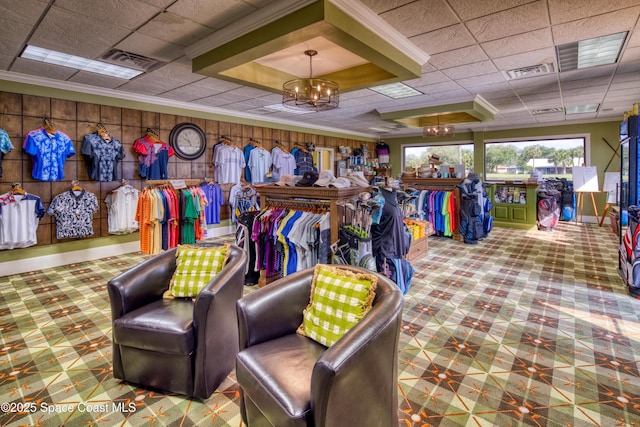 view of property's community featuring a paneled ceiling, crown molding, and a chandelier