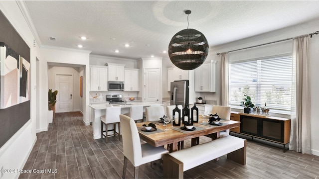 dining space with visible vents, ornamental molding, baseboards, wood finish floors, and recessed lighting