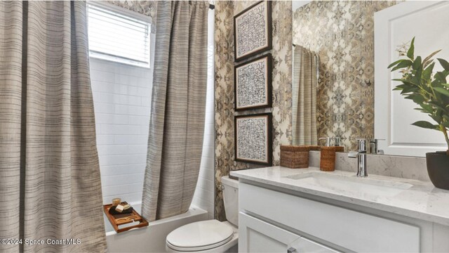 bathroom with vanity, toilet, and shower / bath combination with curtain