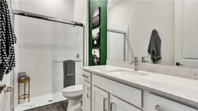 full bathroom with toilet, a shower stall, wood finished floors, and vanity