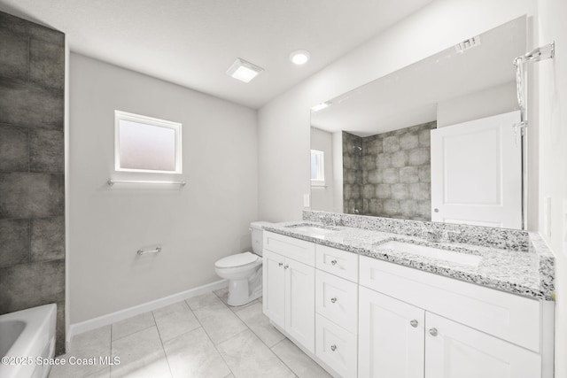 bathroom featuring a sink, baseboards, toilet, and a wealth of natural light
