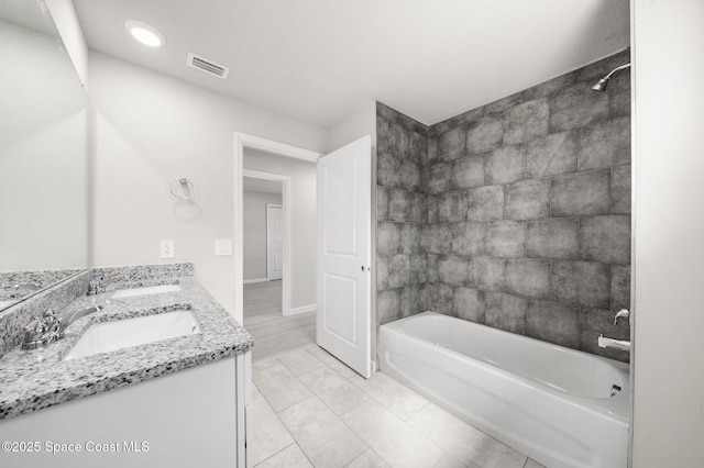 full bathroom featuring double vanity,  shower combination, visible vents, and a sink