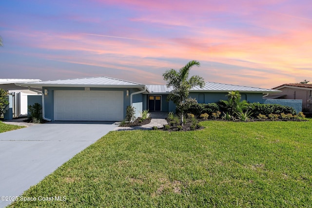 451 Bridgetown Ct, Satellite Beach, FL 32937 - view of front of property featuring stucco siding, a garage, a front yard, and driveway