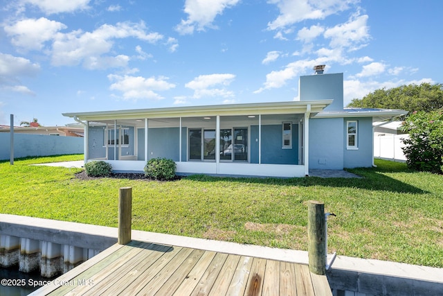 451 Bridgetown Ct, Satellite Beach, FL 32937 - back of property featuring a sunroom, a chimney, and stucco siding