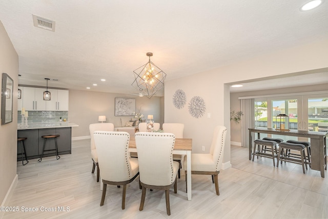 451 Bridgetown Ct, Satellite Beach, FL 32937 - dining area featuring recessed lighting, baseboards, light wood finished floors, and a chandelier