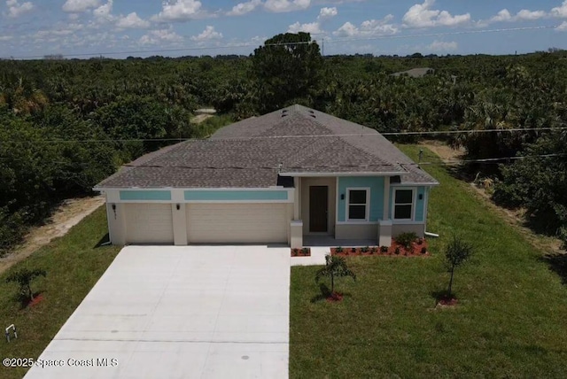 view of front of house featuring driveway, a garage, a view of trees, a front lawn, and stucco siding