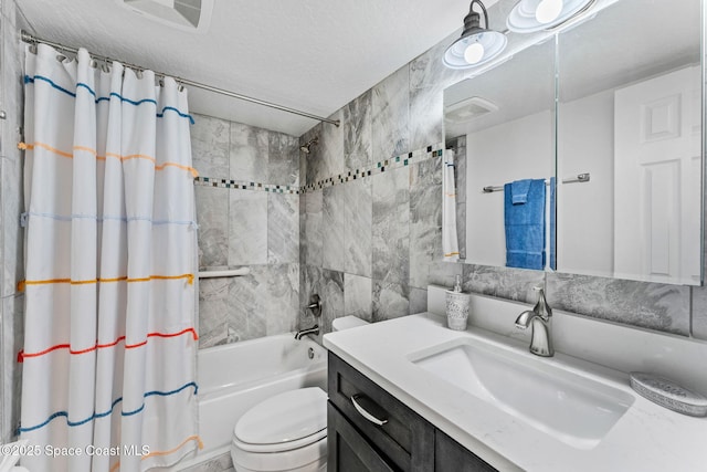 bathroom with shower / tub combo, toilet, vanity, and a textured ceiling