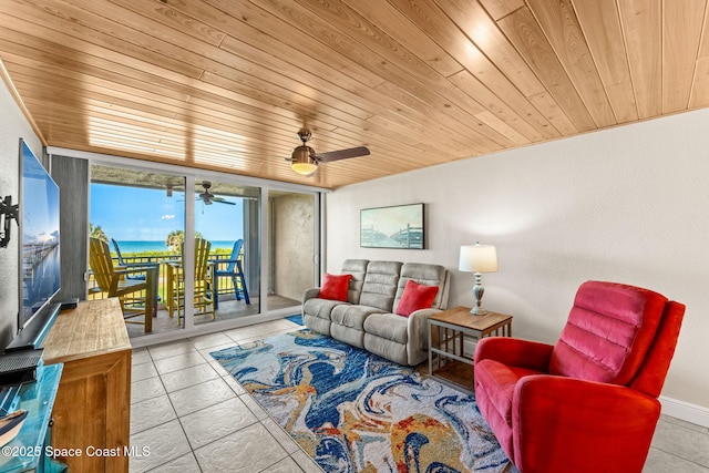 living room featuring wooden ceiling, tile patterned flooring, a ceiling fan, and a water view