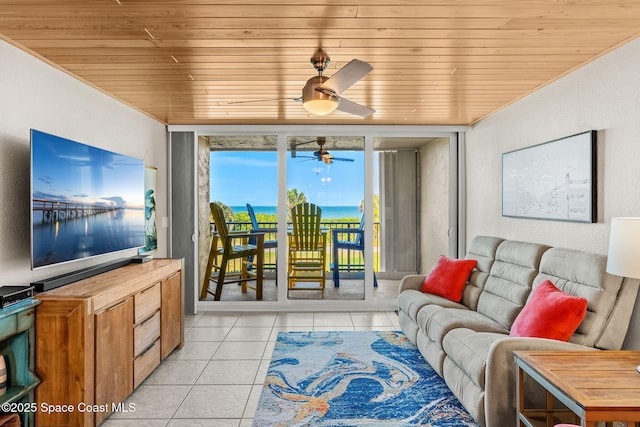 living area with wood ceiling, light tile patterned flooring, a ceiling fan, and a textured wall