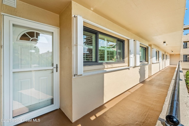 property entrance with stucco siding
