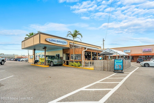 view of commercial property with uncovered parking