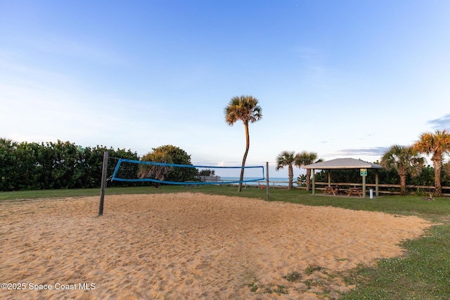 surrounding community with a gazebo, volleyball court, and a water view