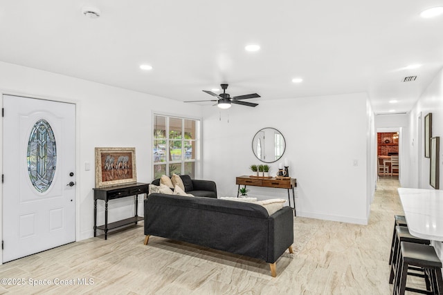 living area with baseboards, ceiling fan, recessed lighting, and visible vents