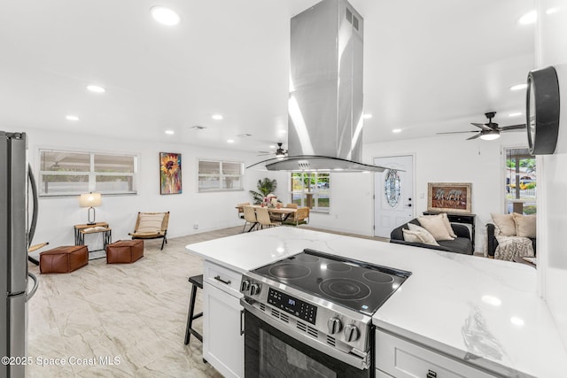 kitchen with ceiling fan, stainless steel appliances, open floor plan, and island range hood