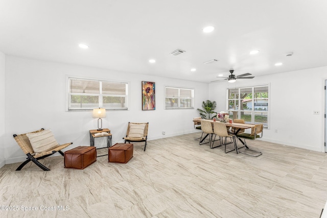 living area featuring recessed lighting, baseboards, and visible vents