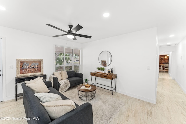 living area featuring baseboards, ceiling fan, and recessed lighting