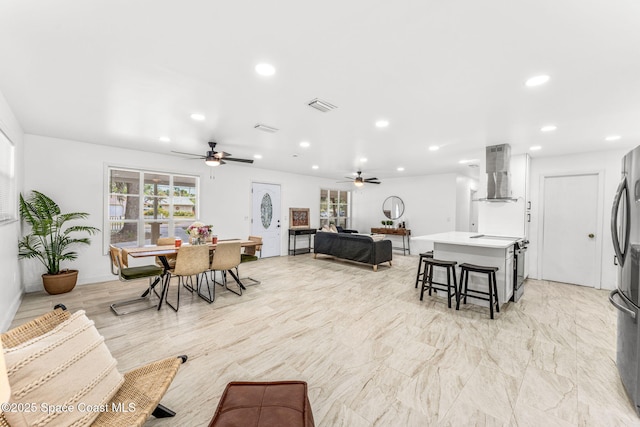 living area with recessed lighting, ceiling fan, and visible vents