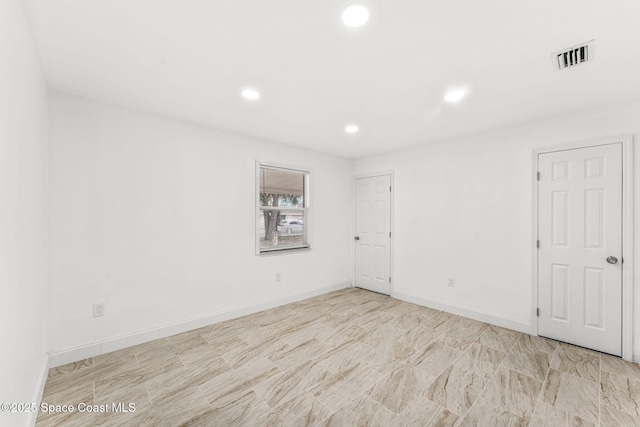 unfurnished room with baseboards, recessed lighting, and visible vents