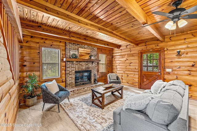 living area with a brick fireplace, ceiling fan, wooden ceiling, and beamed ceiling