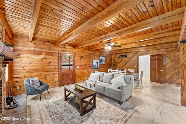 living area with wooden walls, wooden ceiling, beamed ceiling, and a ceiling fan