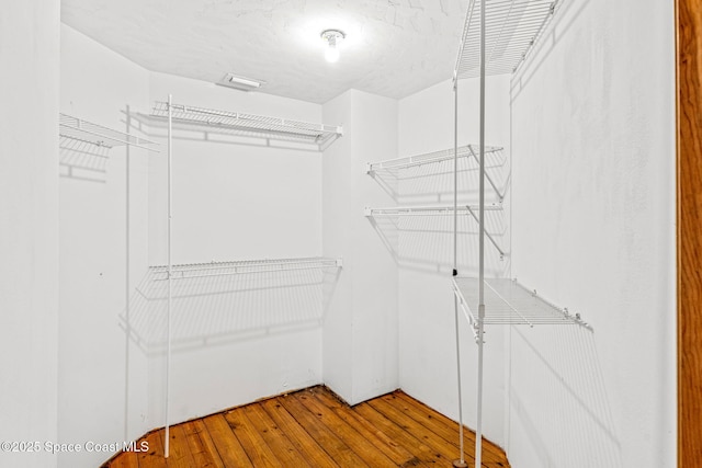 walk in closet featuring hardwood / wood-style floors
