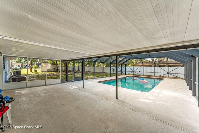 view of swimming pool with a fenced backyard, a patio, and a lanai